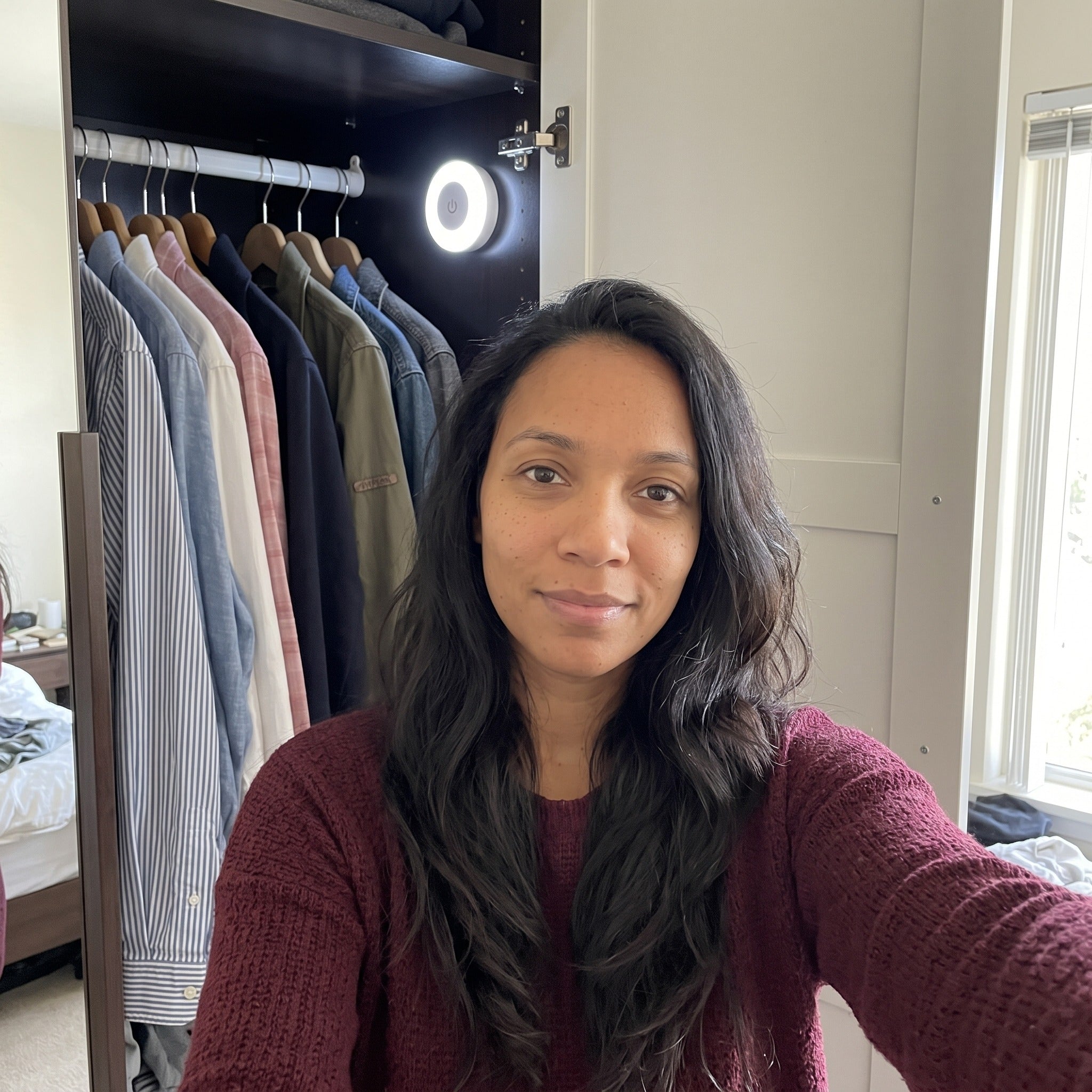 Priya S. beside Little Glow in her wardrobe
